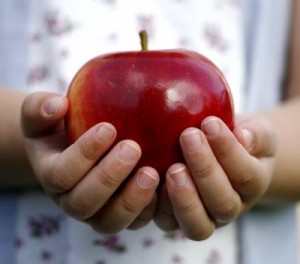 hands holding apple